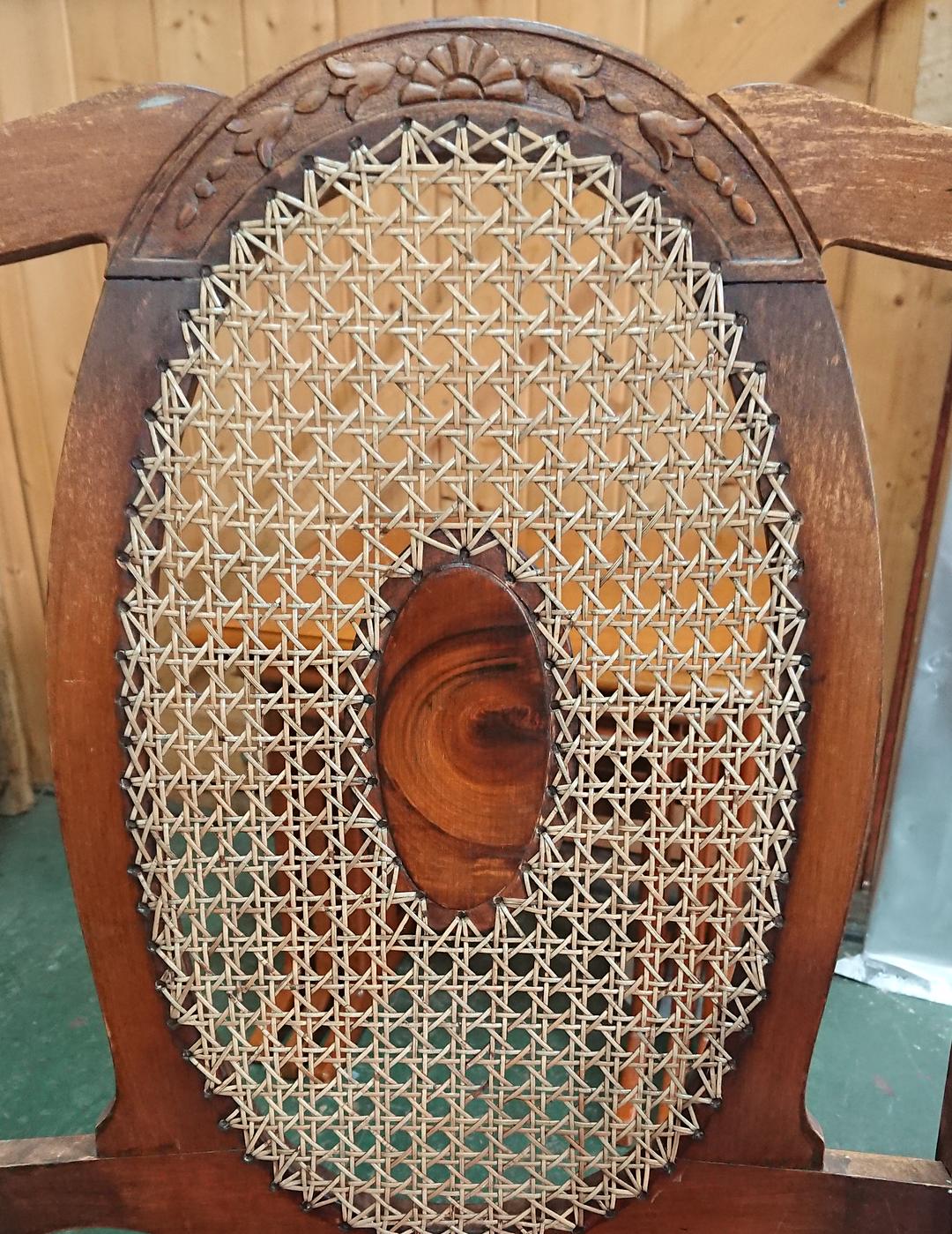 Close crop of an oval chair back, freshly hand caned in the six-way pattern under a carved crest rail