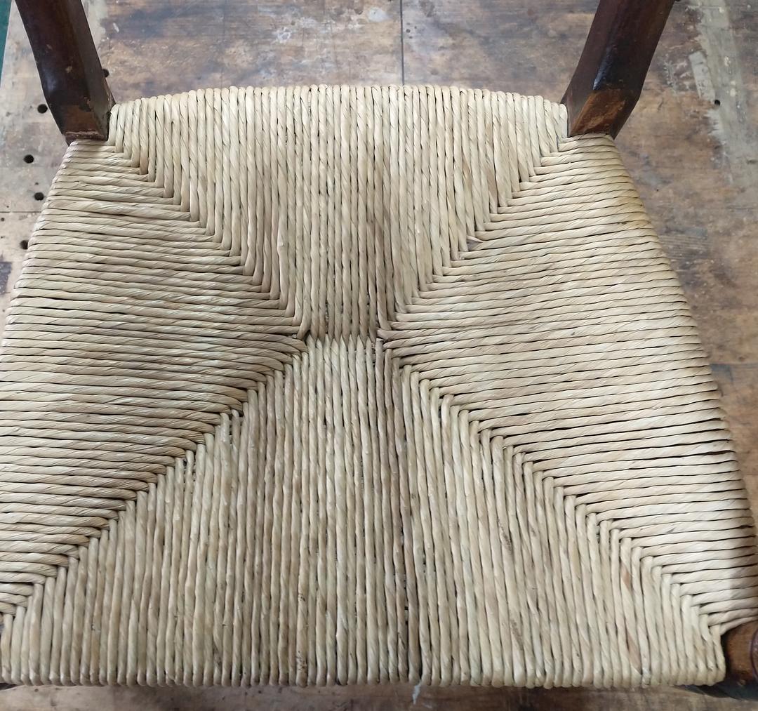 Close-up of a new rush seat, twisted rush meeting in four triangles at the centre