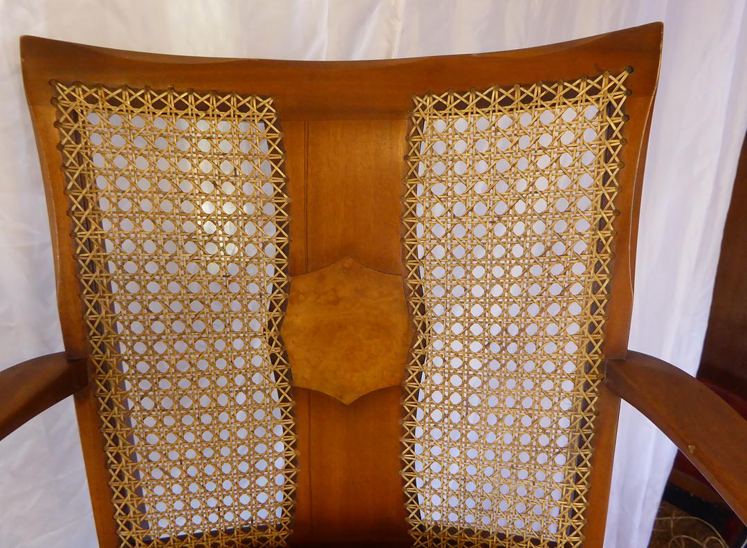 Bergère chair back with two hand-caned panels either side of a figured centre splat