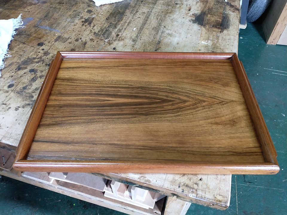 Gallery tray with a strongly figured veneer base, polished, on the workbench