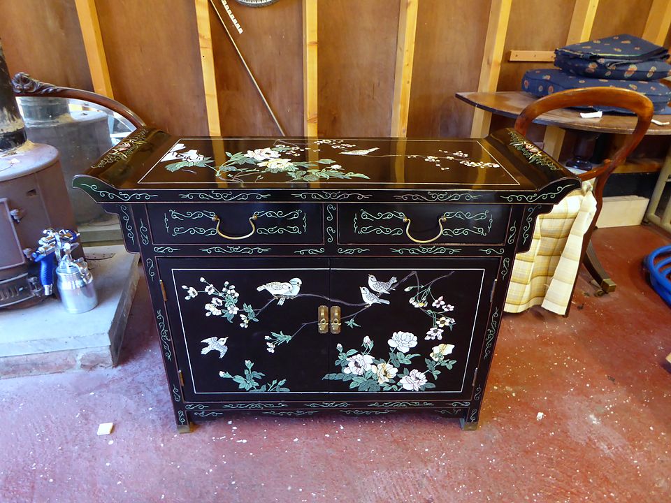 The same black lacquer cabinet with the damaged edge repaired